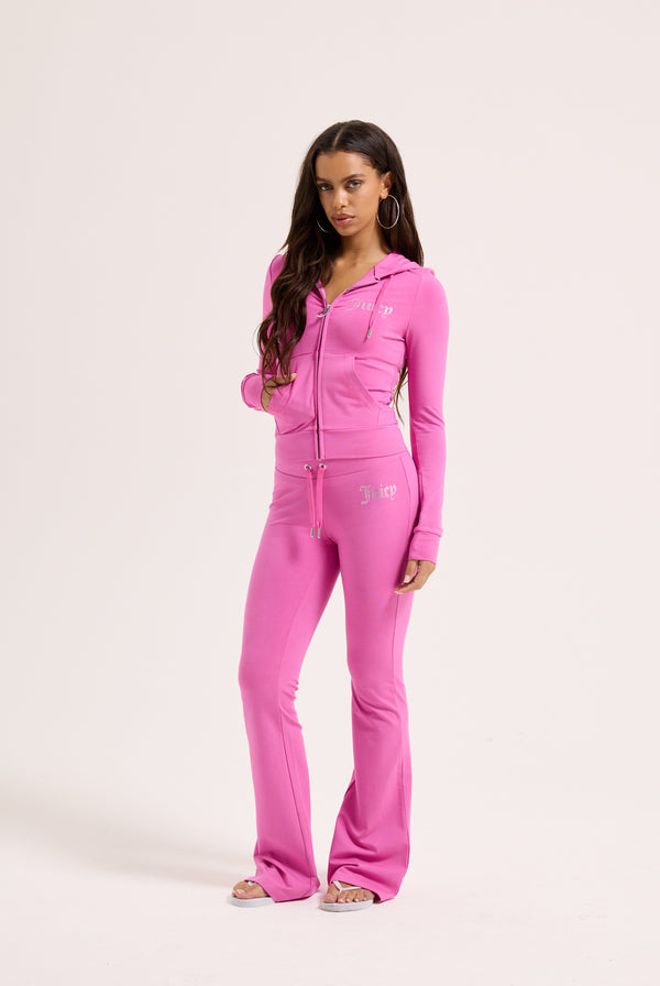 Displays a model wearing the Super Pink 'Juicy' branded Diamanté luxury jersey zip-through hoodie 