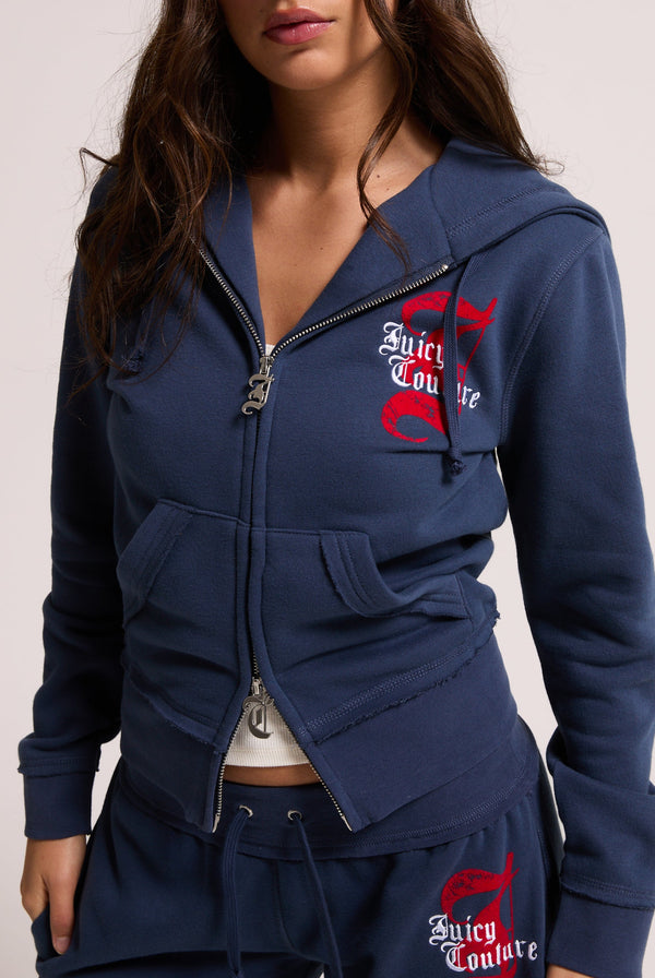 Displays a model wearing the Mood indigo 'juicy' branded longline fleece zip through hoodie 
