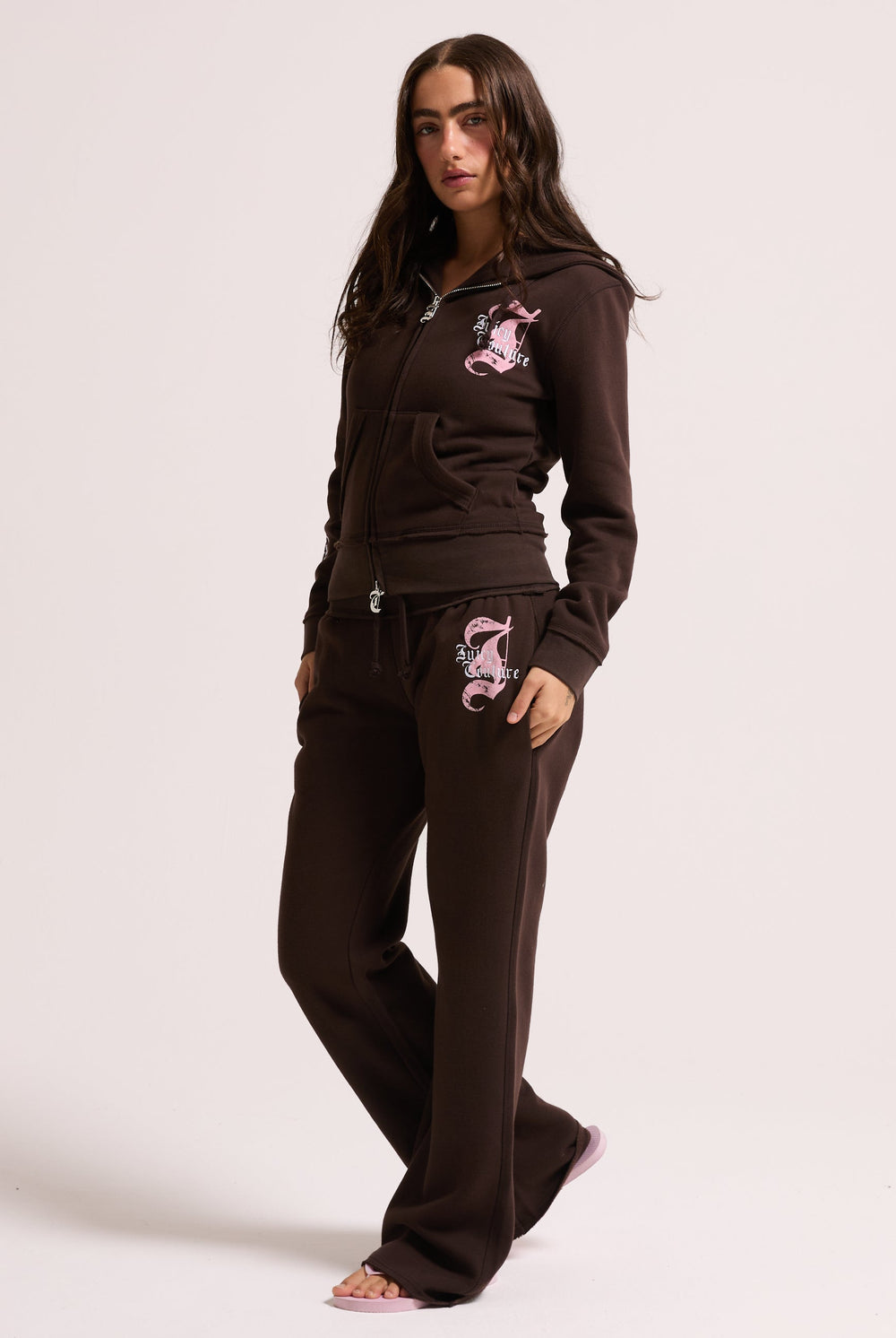 Displays a model wearing the Java longline 'Juicy' branded fleece zip through hoodie 