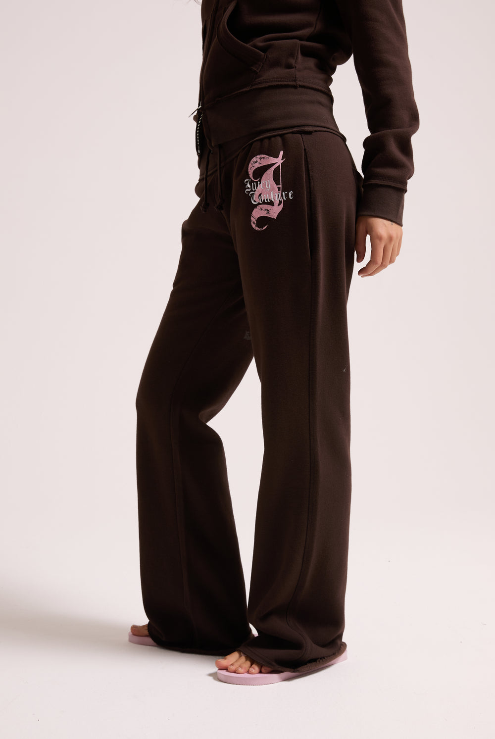 Displays a model wearing the Java 'Juicy' branded relaxed fit flare fleece trackpant
