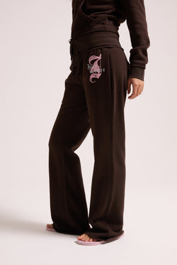 Displays a model wearing the Java 'Juicy' branded relaxed fit flare fleece trackpant