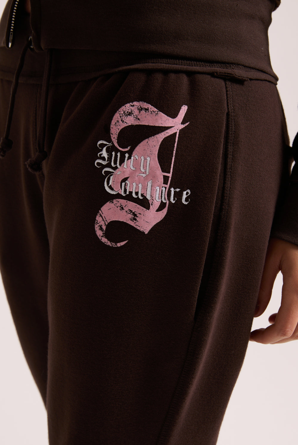 Displays a model wearing the Java 'Juicy' branded relaxed fit flare fleece trackpant
