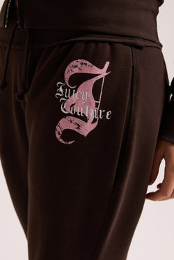 Displays a model wearing the Java 'Juicy' branded relaxed fit flare fleece trackpant