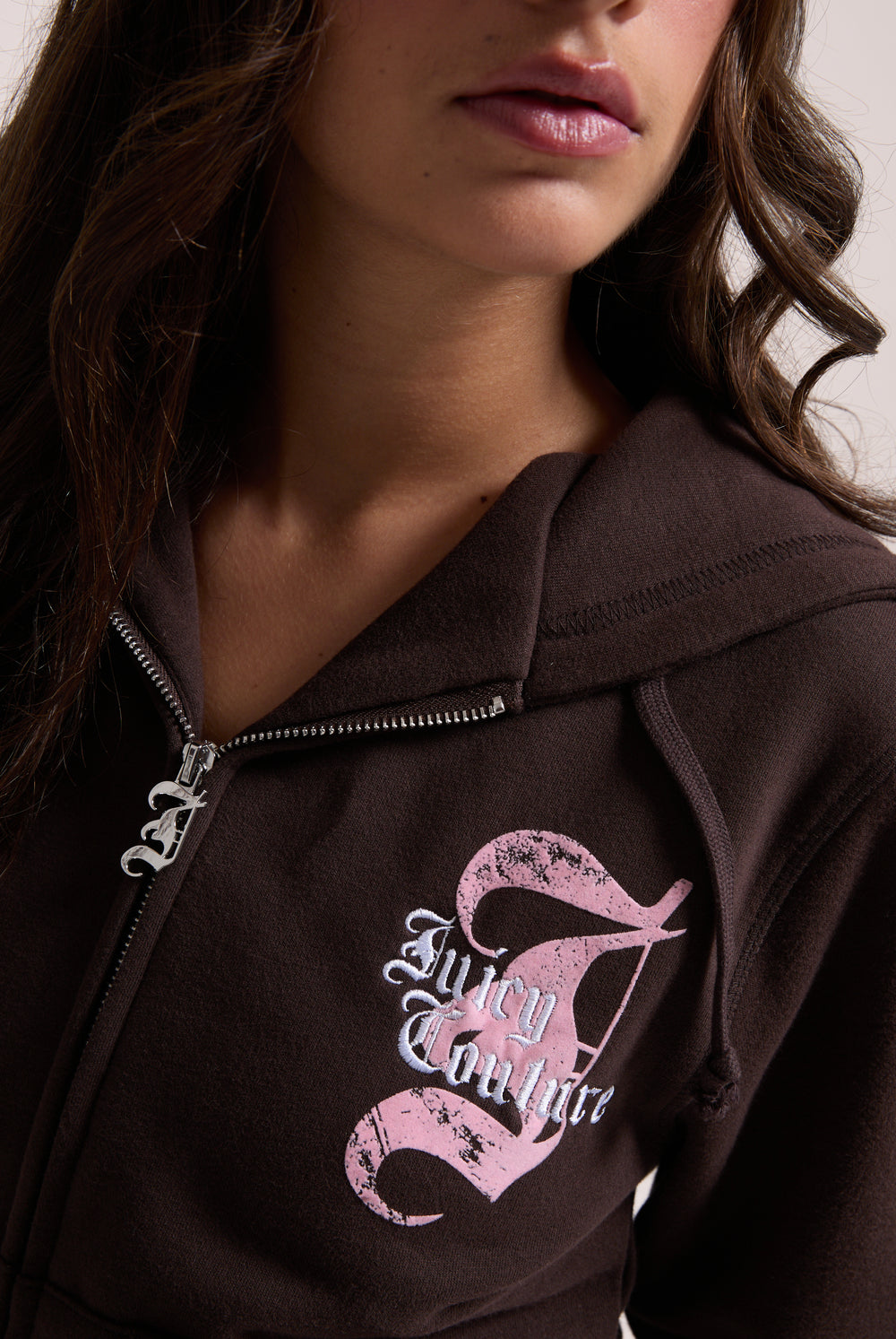Displays a model wearing the Java longline 'Juicy' branded fleece zip through hoodie 