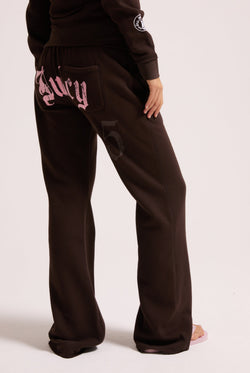 Displays a model wearing the Java 'Juicy' branded relaxed fit flare fleece trackpant