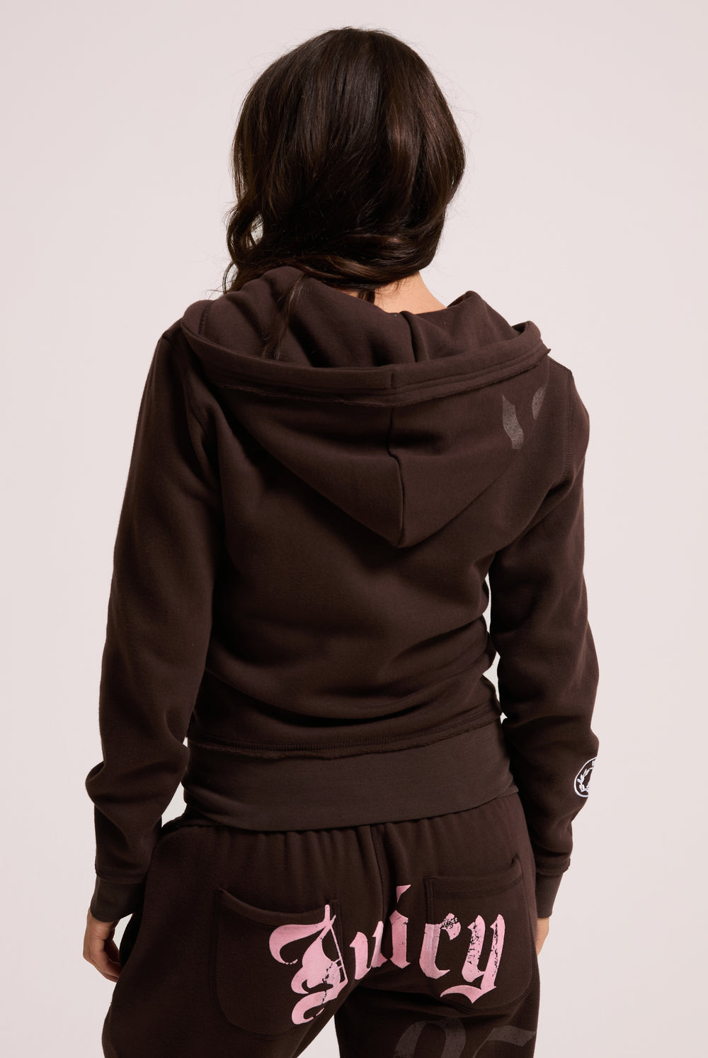 Displays a model wearing the Java longline 'Juicy' branded fleece zip through hoodie 