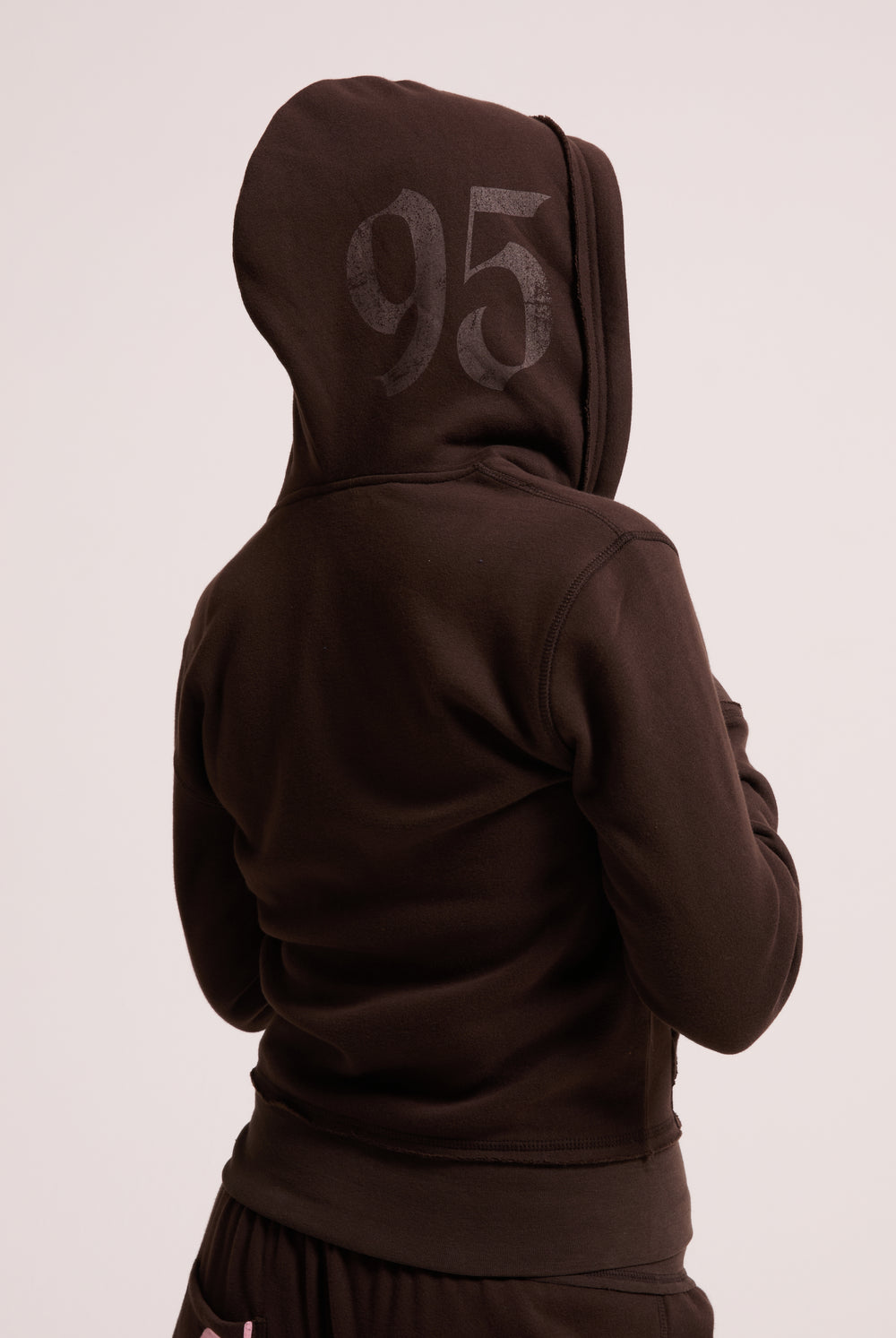 Displays a model wearing the Java longline 'Juicy' branded fleece zip through hoodie 