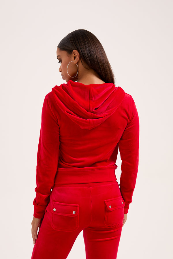 Displays a model wearing the Toreador 'Juicy' branded classic velour Robertson hoodie 