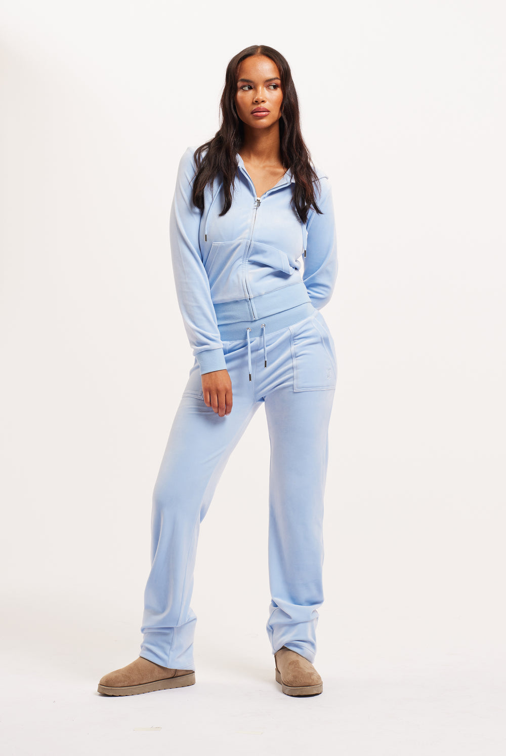 Displays a model wearing the Powder blue classic 'Juicy' branded velour del ray pocketed bottoms 