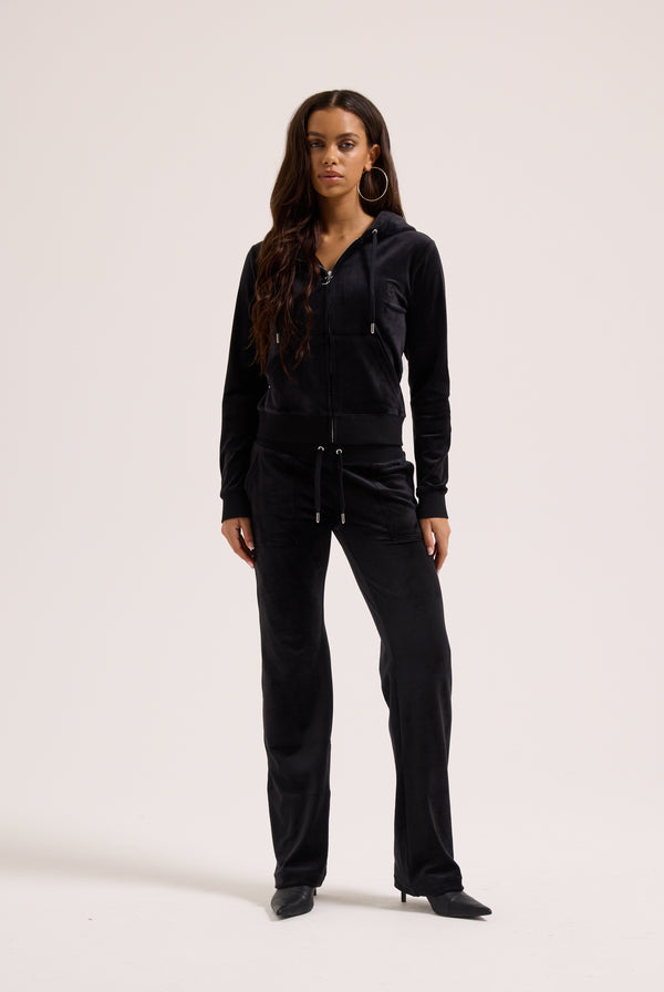 Woman wearing a black outfit on a white background