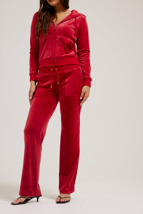 Displays a model wearing the Astor Red 'Juicy' branded classic velour Robertson hoodie 