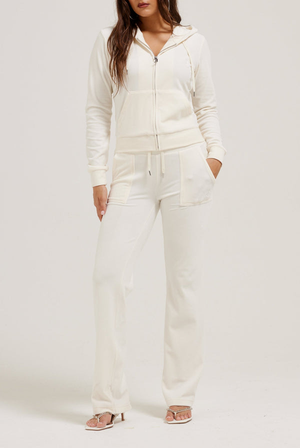 Displays a model wearing the cream classic 'Juicy' branded velour Robertson hoodie 