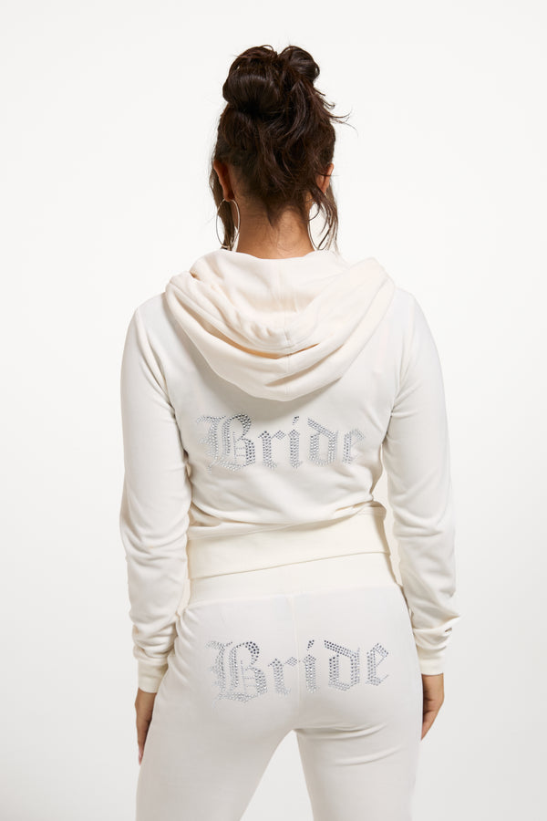 Displays a model wearing the 'Juicy' branded Bridal classic velour hoodie  