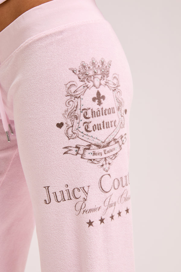 Displays a model wearing the Cherry Blossom 'Juicy' branded Chateau Terry Towelling Trackpant featuring the Juicy Logo