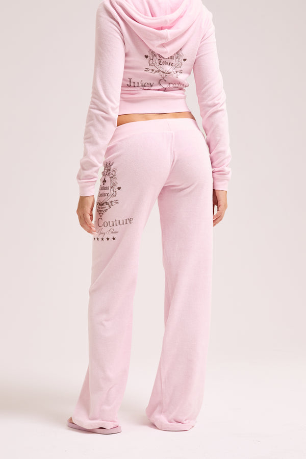 Displays a model wearing the Cherry Blossom 'Juicy' branded Chateau Terry Towelling Trackpant 