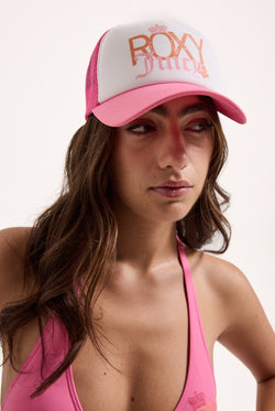 Displays a model wearing the azalea pink Roxy and juicy Couture trucker cap 