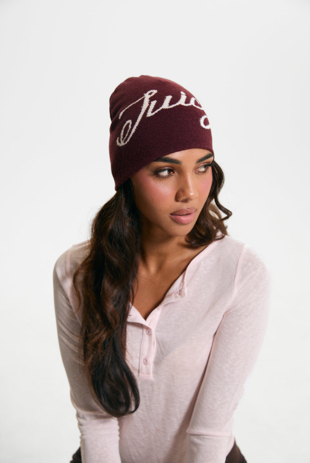 Displays a model wearing the Burgundy 'Juicy' branded Script Beanie
