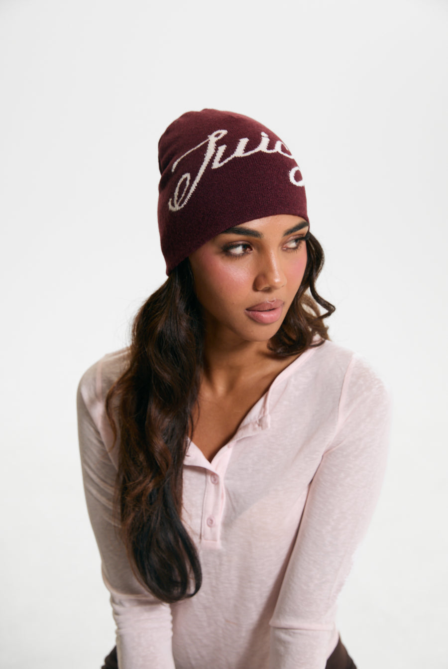 Displays a model wearing the Burgundy 'Juicy' branded Script Beanie