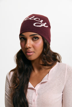 Displays a model wearing the Burgundy 'Juicy' branded Script Beanie