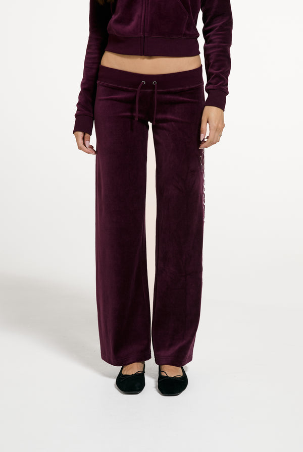 Displays a model wearing the Winetasting 'Juicy' branded Cotton Velour Ultra Lowrise Straight Leg Trackpant