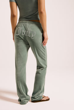 Displays a model wearing the chinois green 'Juicy' velour diamanté tracksuit bottom 