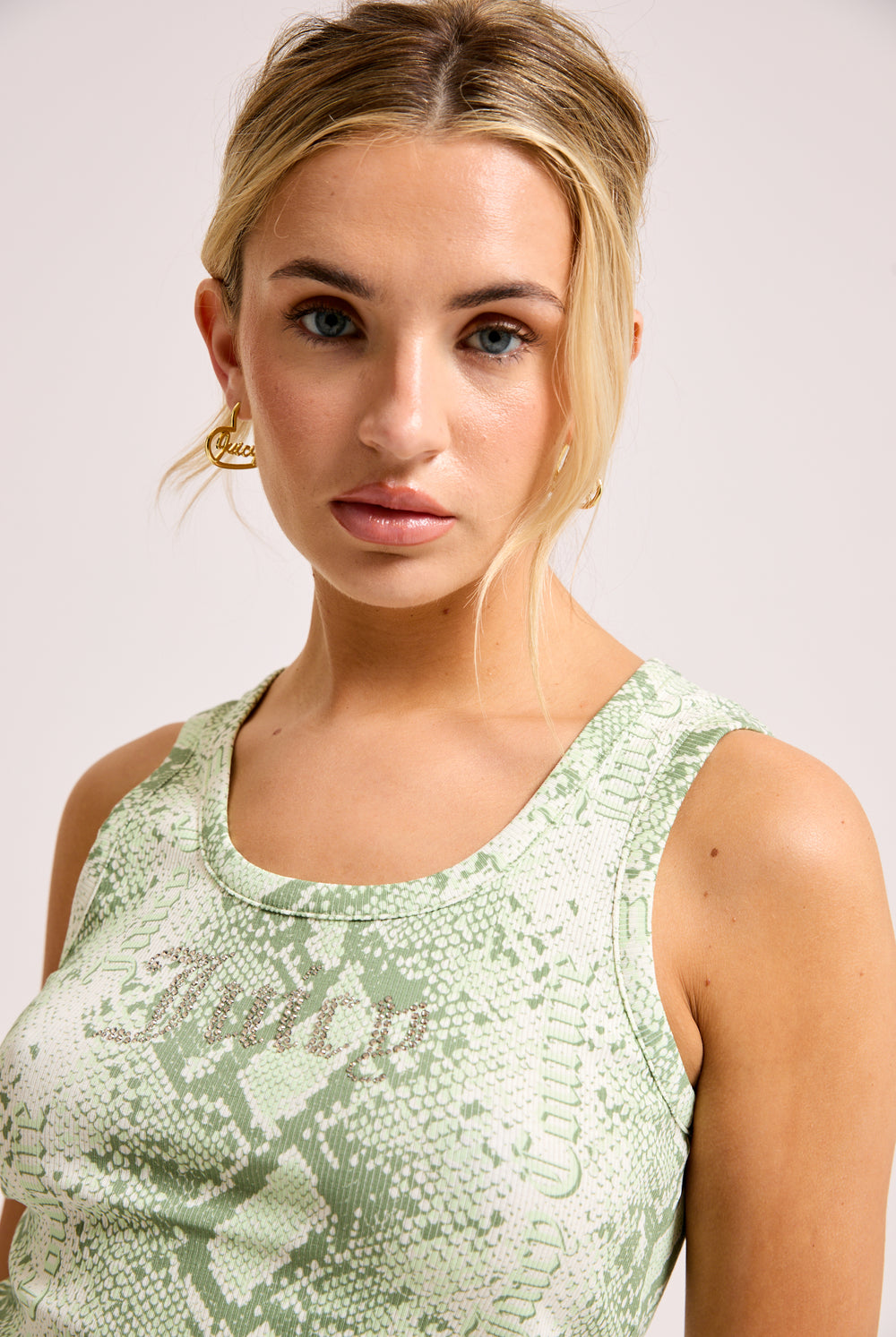 Displays a model wearing the Green Snake print 'Juicy' branded diamanté vest 