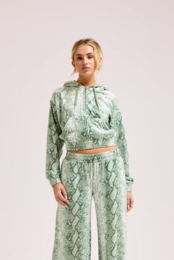 Displays a model wearing the Green snake print 'Juicy' branded diamanté oversized cropped hoodie