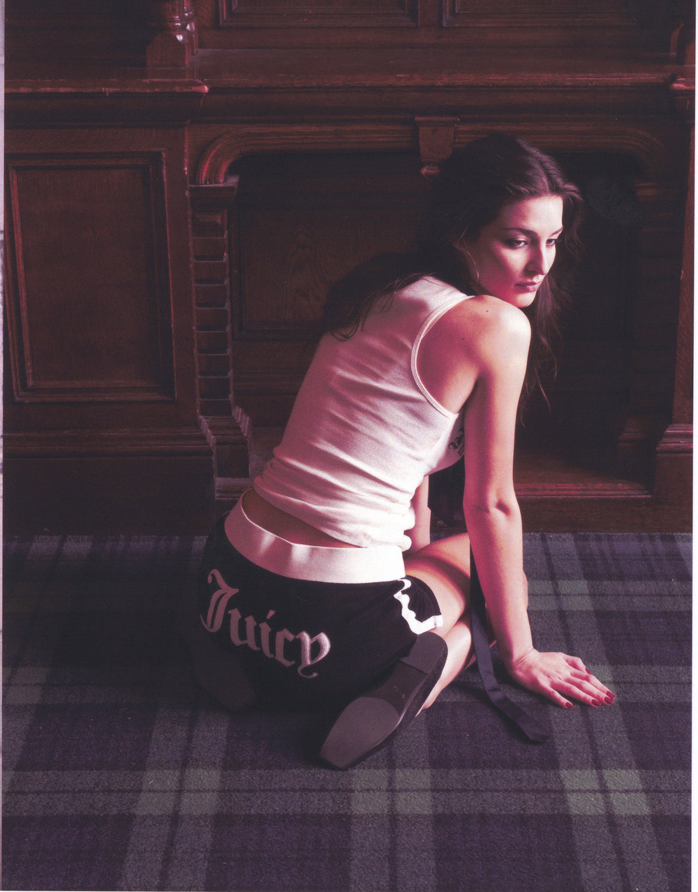 Displays a model wearing the Black Appliqué 'Juicy' branded  Terry booty shorts featuring the juicy branding 