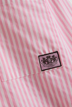 Displays a model wearing the Pink stripe 'Juicy' branded loungewear oversized shirt featuring the juicy Couture logo