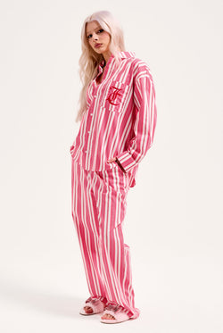 Displays a model wearing the Pink Stripe 'Juicy' branded oversized sleep shirt 