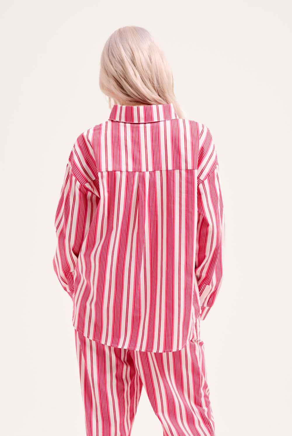 Displays a model wearing the Pink Stripe 'Juicy' branded oversized sleep shirt 