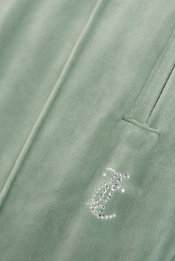 Displays the chinois green 'Juicy' velour diamanté tracksuit bottom featuring the juicy Couture logo