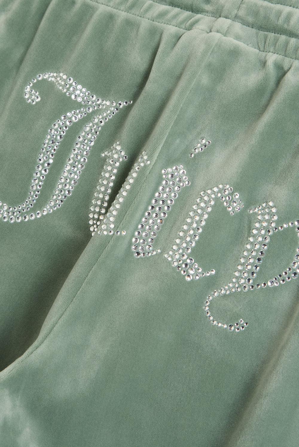 Displays the chinois green 'Juicy' velour diamanté tracksuit bottom featuring the juicy branding 