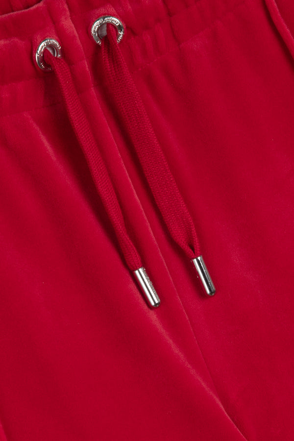 Displays the Astor Red Velour 'Juicy' branded Diamanté tracksuit bottoms 
