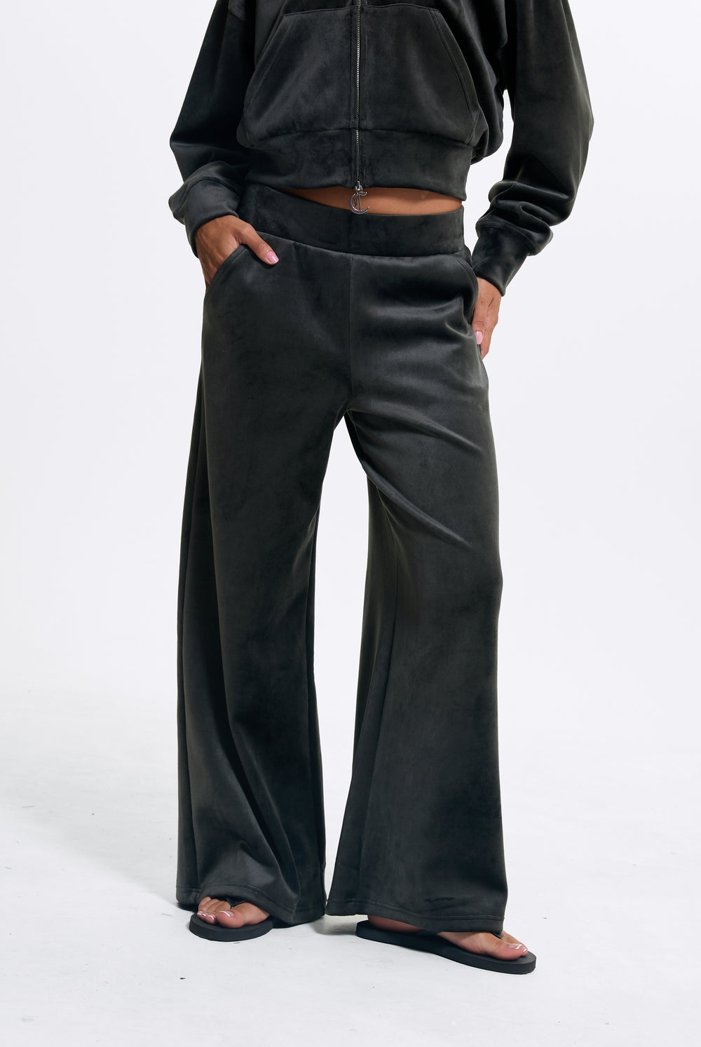Displays a model wearing the Raven 'Juicy' branded Velour Bonded Tracksuit Bottom