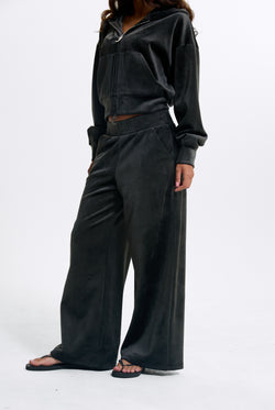 Displays a model wearing the Raven 'Juicy' branded Velour Bonded Tracksuit Bottom