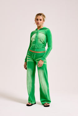 Displays a model wearing the Jolly Green washed 'juicy' branded cotton velour fitted hoodie 