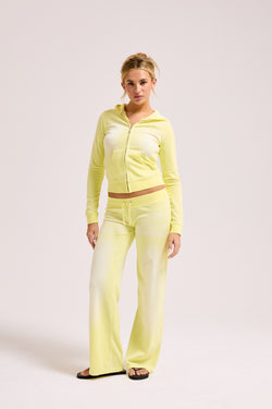 Display a model wearing the Yellow Pear washed 'Juicy' branded cotton velour fitted hoodie 