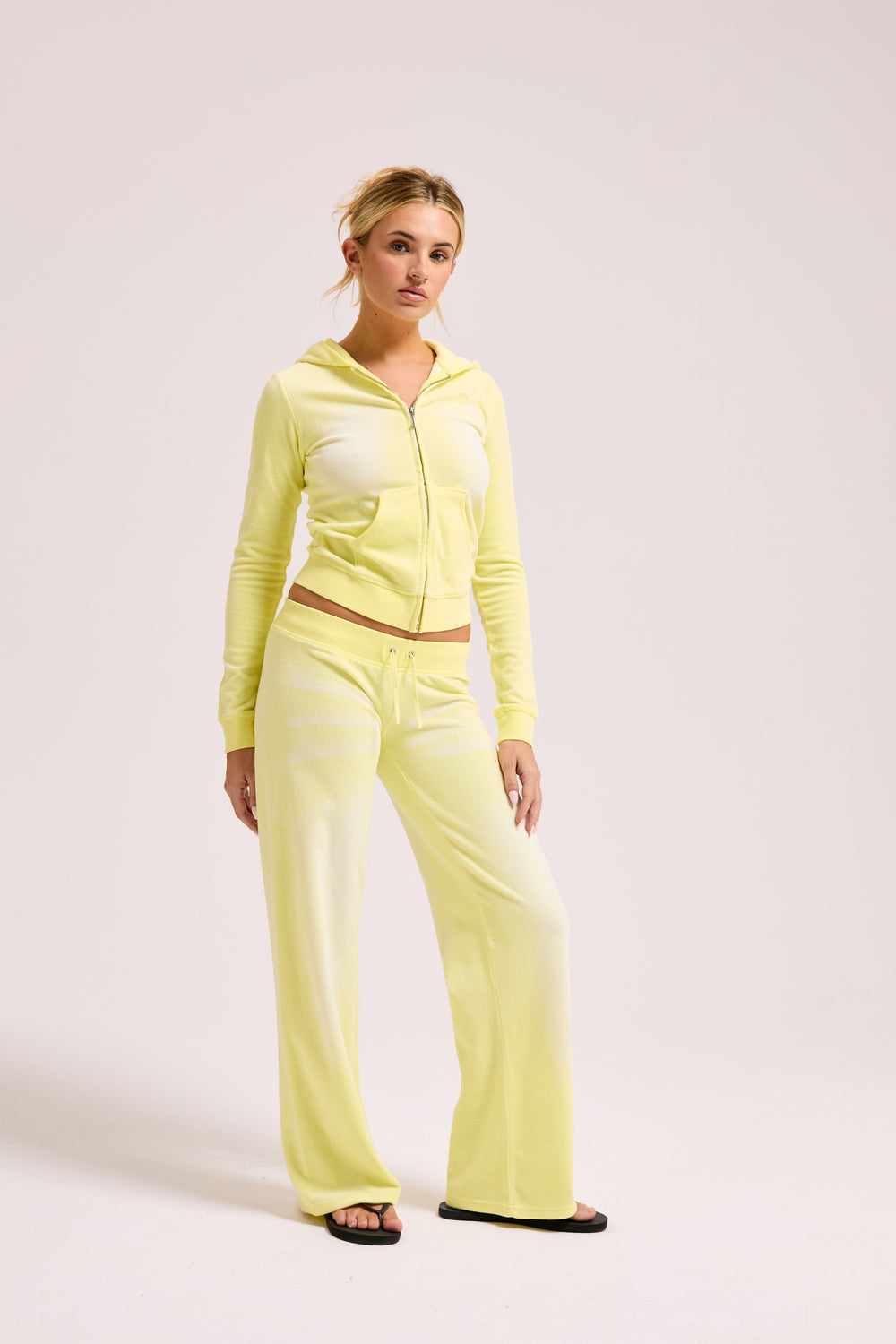 Display a model wearing the Yellow Pear washed 'Juicy' branded cotton velour fitted hoodie 