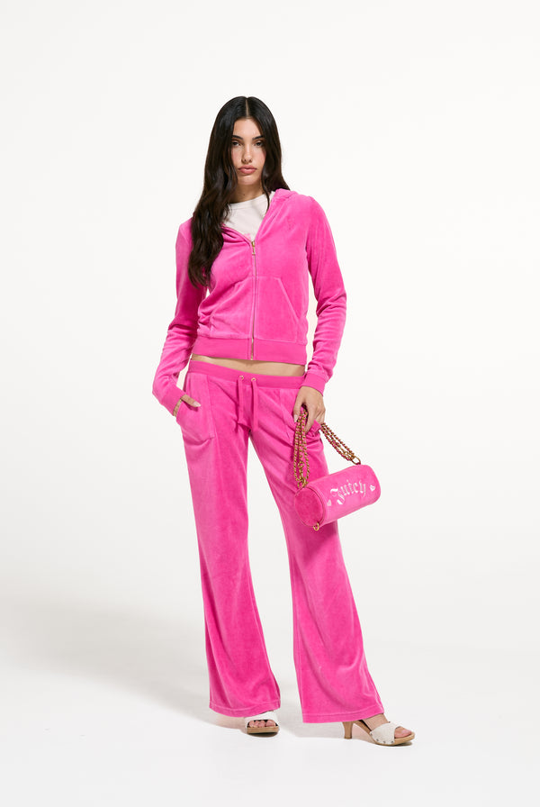 Displays a model wearing the Nostalgia Pink 'Juicy' branded Washed Caisa Ultra Low Rise Pant