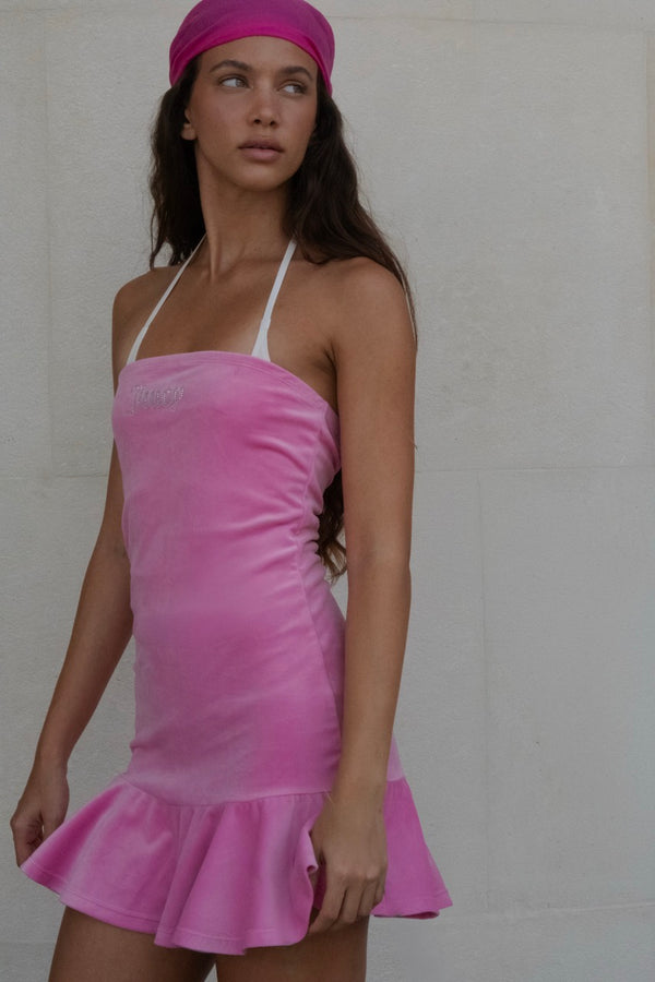Displays a model wearing the super pink 'juicy' branded bandeau velour dress 