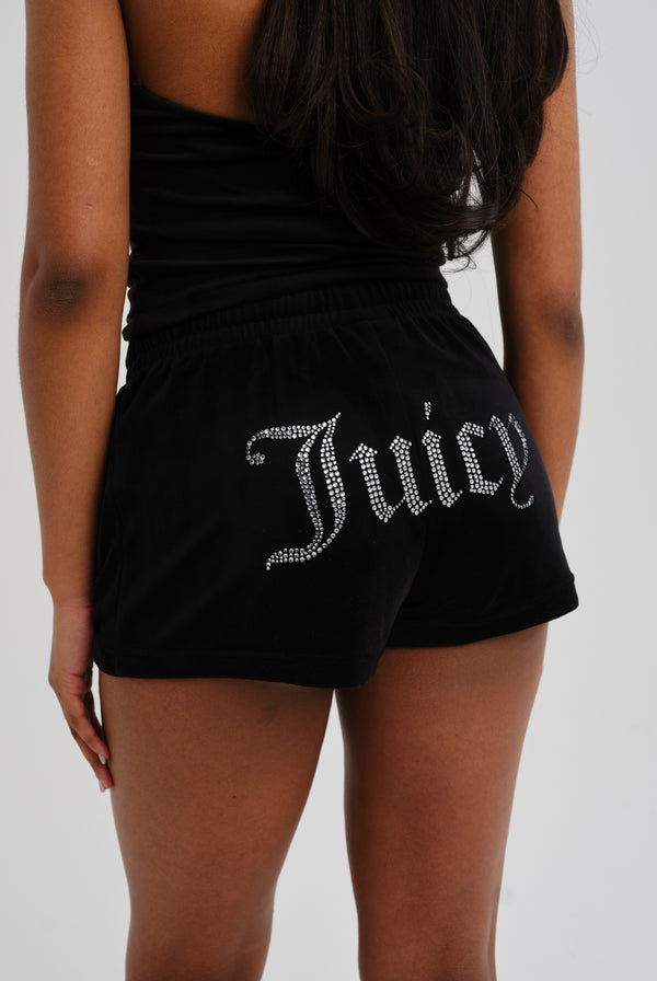 Displays a model wearing the Black 'Juicy' branded velour diamanté track shorts 